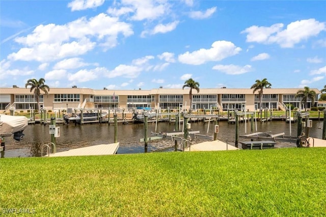 view of dock featuring boat lift, a water view, and a lawn
