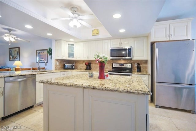 4722 SE 1st Pl Unit 12, Cape Coral, FL 33904 - kitchen with stainless steel appliances, ceiling fan, tasteful backsplash, white cabinets, and recessed lighting
