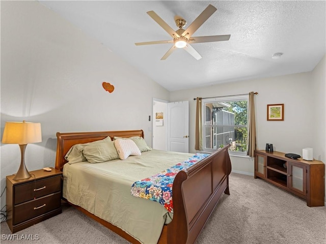 507 NE 31st St, Cape Coral, FL 33909 - bedroom with light colored carpet, a textured ceiling, vaulted ceiling, a ceiling fan, and baseboards
