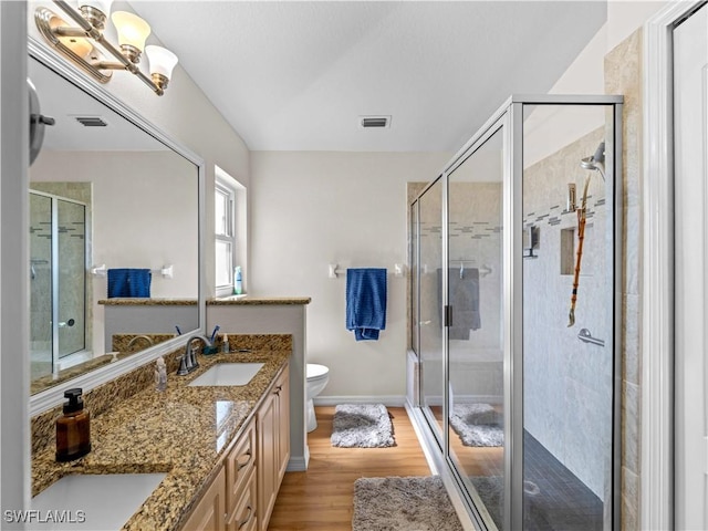 507 NE 31st St, Cape Coral, FL 33909 - bathroom featuring a shower stall, visible vents, a sink, and wood finished floors