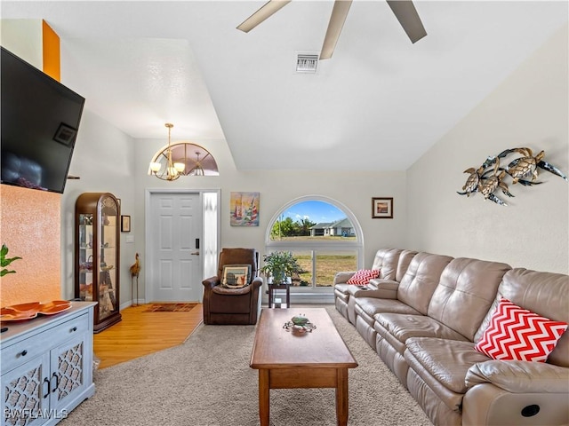 507 NE 31st St, Cape Coral, FL 33909 - living room featuring light colored carpet, visible vents, lofted ceiling, and ceiling fan with notable chandelier