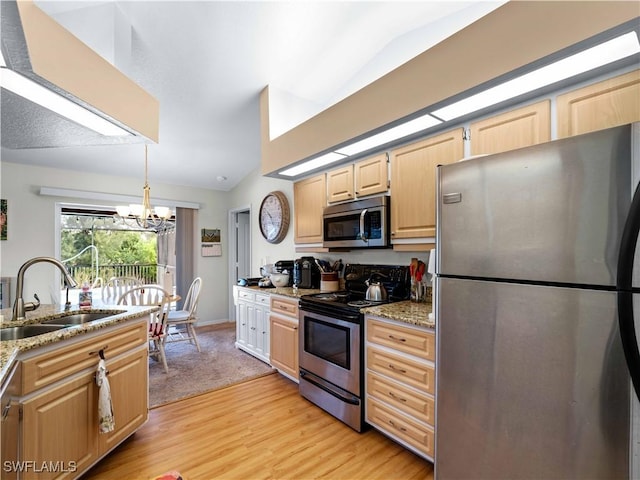 507 NE 31st St, Cape Coral, FL 33909 - kitchen featuring a sink, an inviting chandelier, stainless steel appliances, and light brown cabinetry