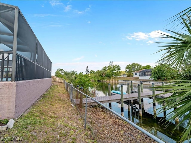 507 NE 31st St, Cape Coral, FL 33909 - view of dock featuring a water view, fence, and glass enclosure