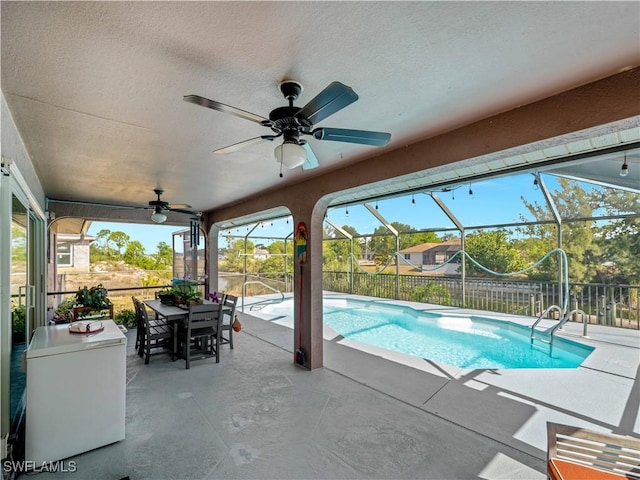 507 NE 31st St, Cape Coral, FL 33909 - view of pool featuring a patio area, a lanai, outdoor dining space, a fenced in pool, and a ceiling fan