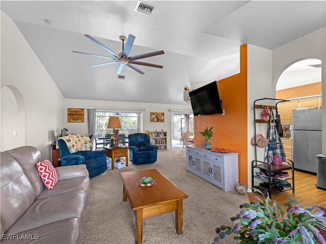 507 NE 31st St, Cape Coral, FL 33909 - living room featuring vaulted ceiling, visible vents, a ceiling fan, and arched walkways