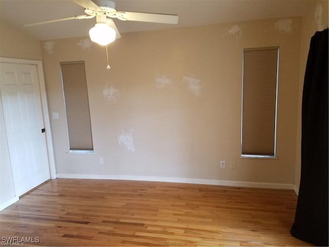 880 18th St NE, Naples, FL 34120 - spare room with baseboards, light wood finished floors, and ceiling fan