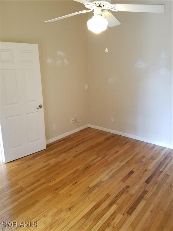 880 18th St NE, Naples, FL 34120 - spare room with ceiling fan, baseboards, and light wood-type flooring