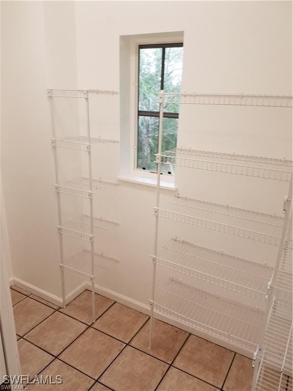 880 18th St NE, Naples, FL 34120 - walk in closet with light tile patterned flooring