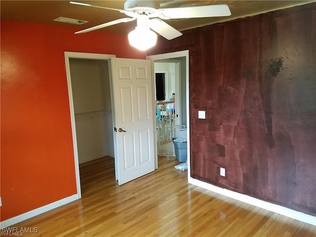 880 18th St NE, Naples, FL 34120 - unfurnished bedroom with baseboards, a closet, light wood-type flooring, and visible vents