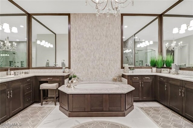 4605 Azalea Dr, Naples, FL 34119 - full bathroom with a chandelier, a shower stall, and two vanities
