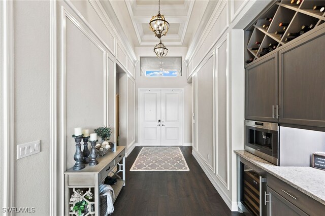 4605 Azalea Dr, Naples, FL 34119 - doorway with wine cooler, ornamental molding, dark wood finished floors, a chandelier, and a raised ceiling