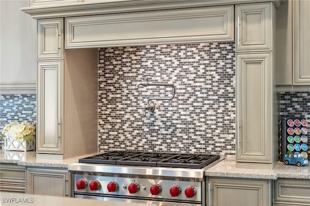 4605 Azalea Dr, Naples, FL 34119 - kitchen with high end stainless steel range, backsplash, and light stone countertops