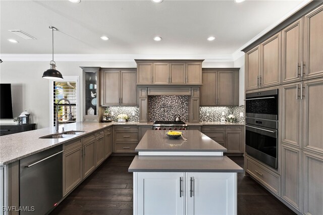 4605 Azalea Dr, Naples, FL 34119 - kitchen with appliances with stainless steel finishes, a peninsula, ornamental molding, a kitchen island, and dark wood-style floors