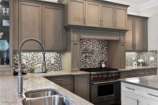4605 Azalea Dr, Naples, FL 34119 - kitchen featuring designer range, backsplash, crown molding, and light stone countertops