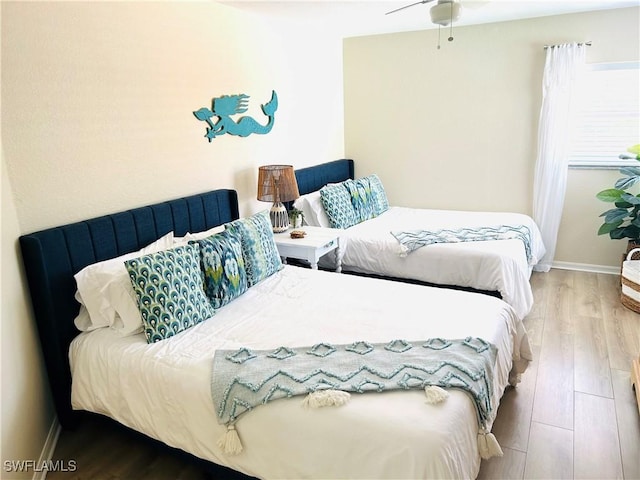bedroom with wood finished floors and baseboards