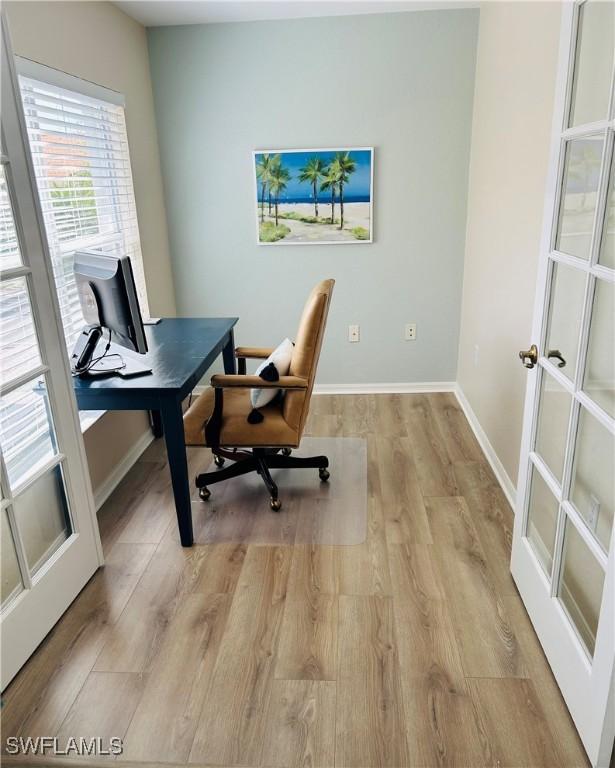 office space with light wood-style floors and baseboards