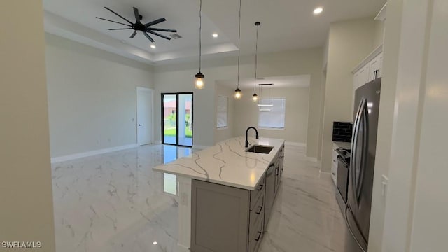 kitchen with freestanding refrigerator, baseboards, recessed lighting, and a sink