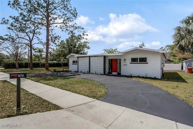 1478 Cordova Ave, Fort Myers, FL 33901 - mid-century inspired home with a front lawn, asphalt driveway, and stucco siding
