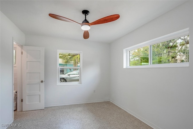1478 Cordova Ave, Fort Myers, FL 33901 - unfurnished bedroom with multiple windows, speckle patterned floor, and ceiling fan
