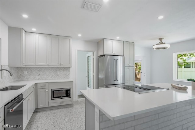 1478 Cordova Ave, Fort Myers, FL 33901 - kitchen featuring stainless steel appliances, a sink, recessed lighting, dark aggregate flooring, and tasteful backsplash