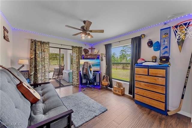 bedroom with baseboards, access to outside, ceiling fan, and wood finished floors