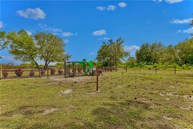 view of yard featuring a rural view and fence
