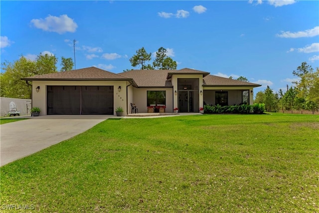 prairie-style home with concrete driveway, stucco siding, a front lawn, and an attached garage