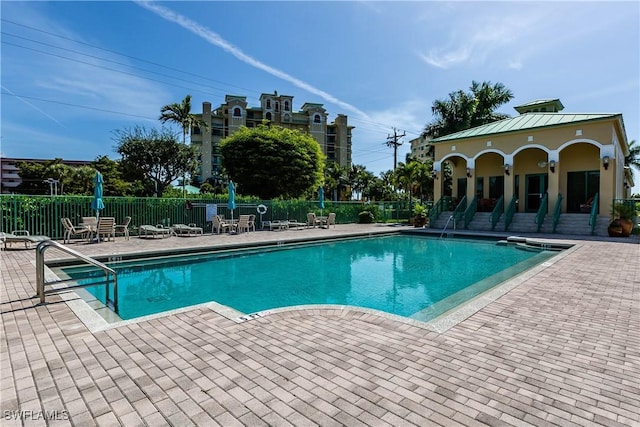 1079 Bald Eagle Dr Unit N703, Marco Island, FL 34145 - pool with a patio and fence