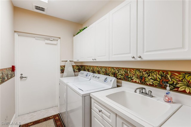 1079 Bald Eagle Dr Unit N703, Marco Island, FL 34145 - washroom with visible vents, a sink, tile patterned flooring, separate washer and dryer, and cabinet space