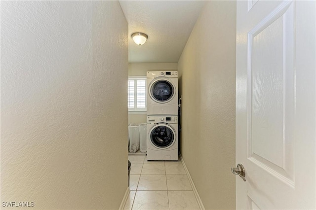 5010 La Costa Island Ct, Punta Gorda, FL 33950 - laundry room with stacked washer / dryer, a textured wall, and baseboards