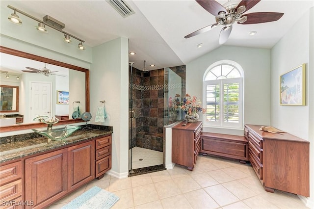5010 La Costa Island Ct, Punta Gorda, FL 33950 - bathroom with a ceiling fan, lofted ceiling, a shower stall, vanity, and tile patterned flooring