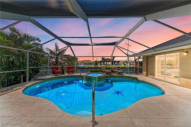 5010 La Costa Island Ct, Punta Gorda, FL 33950 - pool at dusk featuring a patio area, a pool with connected hot tub, and a lanai