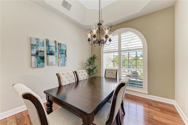 5010 La Costa Island Ct, Punta Gorda, FL 33950 - dining space featuring a chandelier, baseboards, and light wood-style floors