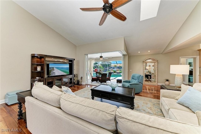 5010 La Costa Island Ct, Punta Gorda, FL 33950 - living area with a ceiling fan, wood finished floors, baseboards, a skylight, and high vaulted ceiling