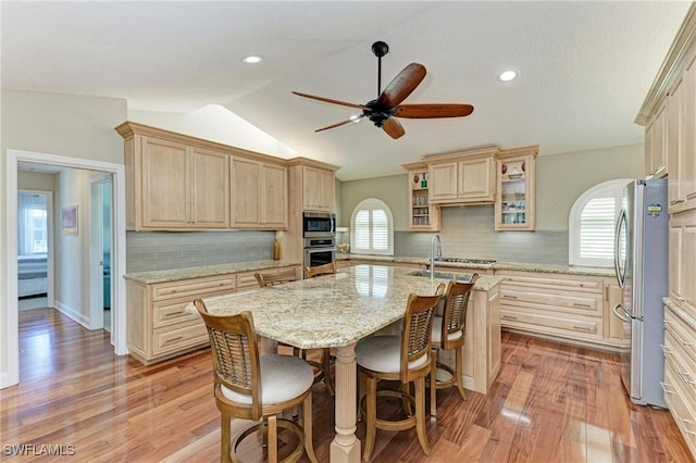 5010 La Costa Island Ct, Punta Gorda, FL 33950 - kitchen with stainless steel appliances, a kitchen island with sink, plenty of natural light, ceiling fan, and lofted ceiling