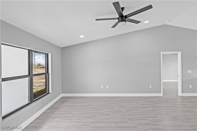 empty room featuring vaulted ceiling, ceiling fan, baseboards, and recessed lighting
