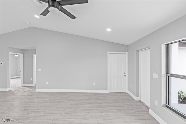 empty room featuring recessed lighting, vaulted ceiling, light wood finished floors, a ceiling fan, and baseboards
