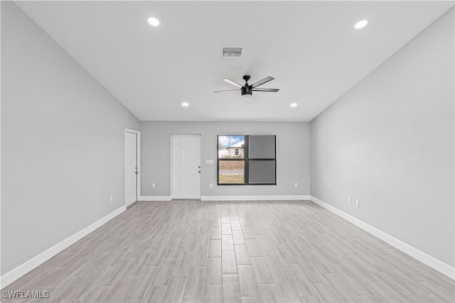 unfurnished room with baseboards, a ceiling fan, visible vents, and light wood-style floors