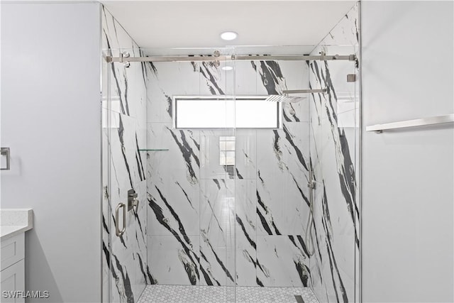 full bathroom with vanity and a marble finish shower