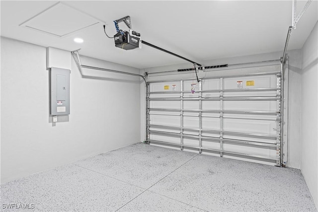 garage featuring electric panel, a garage door opener, and recessed lighting