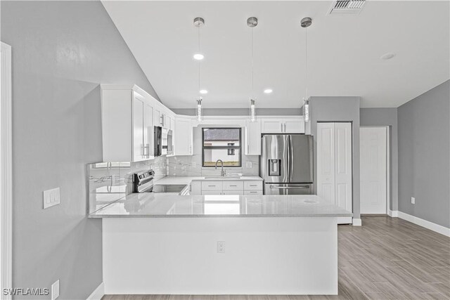 kitchen with a sink, visible vents, decorative backsplash, baseboards, and appliances with stainless steel finishes