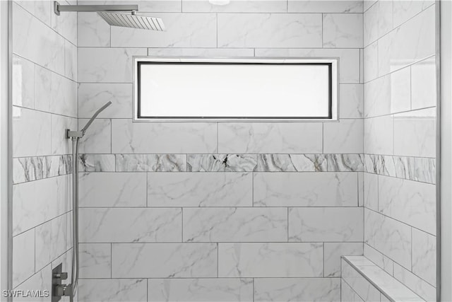 room details featuring a tile shower