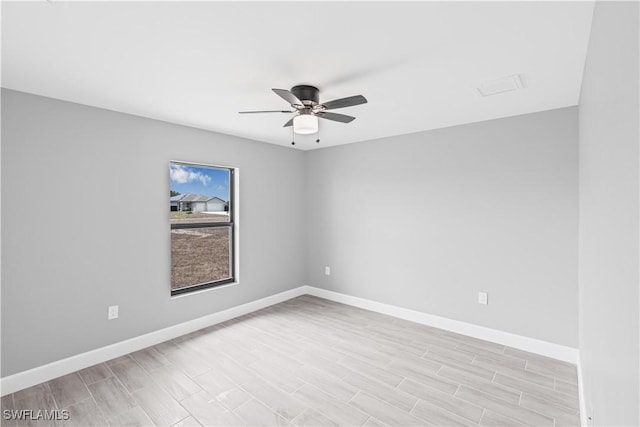 unfurnished room featuring baseboards, light wood-style flooring, and ceiling fan
