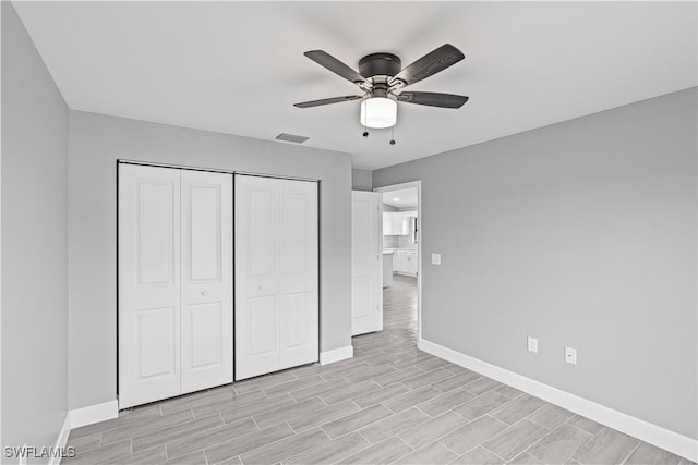 unfurnished bedroom with a ceiling fan, a closet, baseboards, light wood finished floors, and visible vents