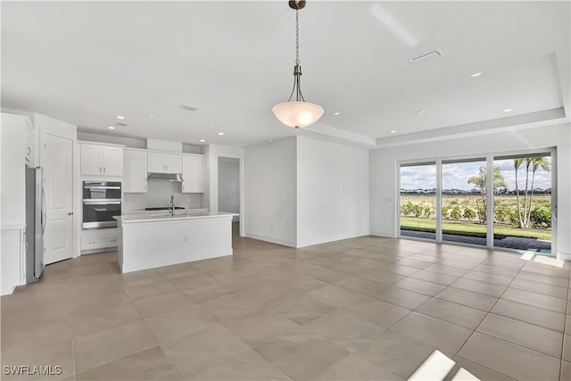 44494 Little Blue Heron Way, Punta Gorda, FL 33982 - kitchen with appliances with stainless steel finishes, open floor plan, a sink, light tile patterned flooring, and recessed lighting