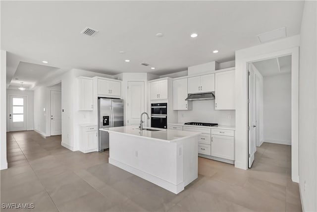 44494 Little Blue Heron Way, Punta Gorda, FL 33982 - kitchen with stainless steel fridge with ice dispenser, under cabinet range hood, double oven, white cabinetry, and light countertops