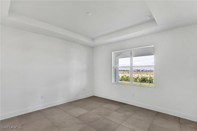 44494 Little Blue Heron Way, Punta Gorda, FL 33982 - tiled spare room with a raised ceiling and baseboards