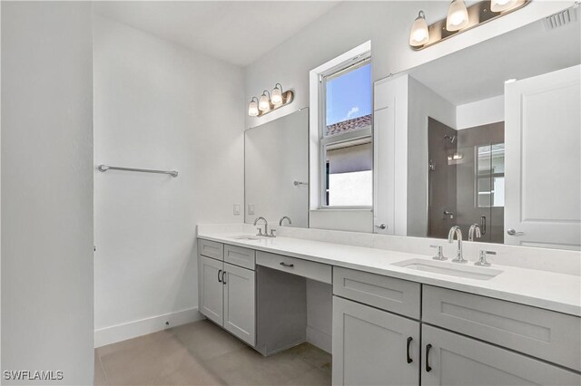 44494 Little Blue Heron Way, Punta Gorda, FL 33982 - bathroom featuring a shower stall, baseboards, and double vanity