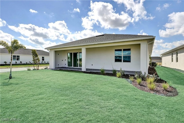 44494 Little Blue Heron Way, Punta Gorda, FL 33982 - back of property featuring a yard and stucco siding