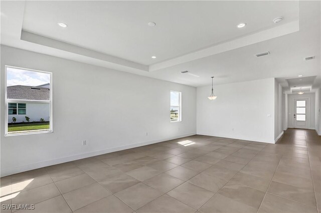 44494 Little Blue Heron Way, Punta Gorda, FL 33982 - spare room with a tray ceiling, light tile patterned floors, recessed lighting, baseboards, and a smoke detector